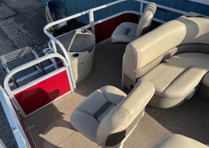 Slide: The Image of 2023 Sun Tracker Bass Buggy 18 DLX pontoon boat with beige seating and red accents. - 19