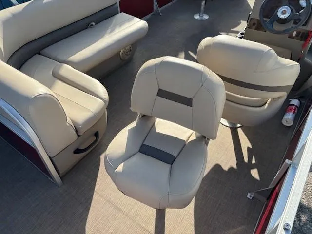 Slide: The Image of 2023 Sun Tracker Bass Buggy 18 DLX interior with beige seating and steering wheel. - 20