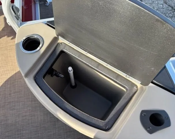 Slide: The Image of 2023 Sun Tracker Bass Buggy 18 DLX livewell with open lid and cup holder. - 23