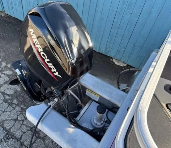 Slide: The Image of 2023 Sun Tracker Bass Buggy 18 DLX with Mercury outboard motor, blue background. - 24