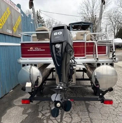 Slide: The Image of 2023 Sun Tracker Bass Buggy 18 DLX pontoon boat with 60 HP engine, rear view. - 4