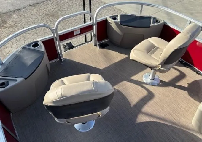 Slide: The Image of 2023 Sun Tracker Bass Buggy 18 DLX interior with beige seating and red accents. - 5