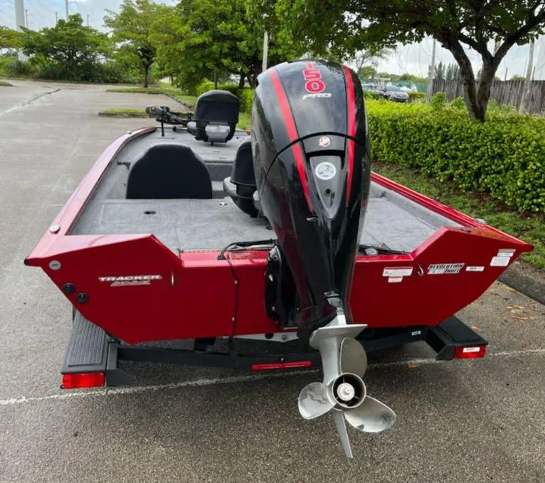 Slide: The Image of 2025 Tracker Pro Team 195 Tournament Edition boat with outboard motor in parking lot. - 3