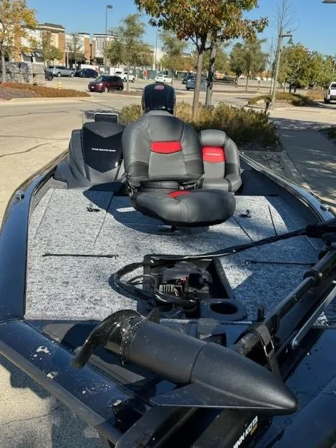 Slide: The Image of 2025 Tracker Pro Team 190 fishing boat with seating and equipment, parked outdoors. - 3