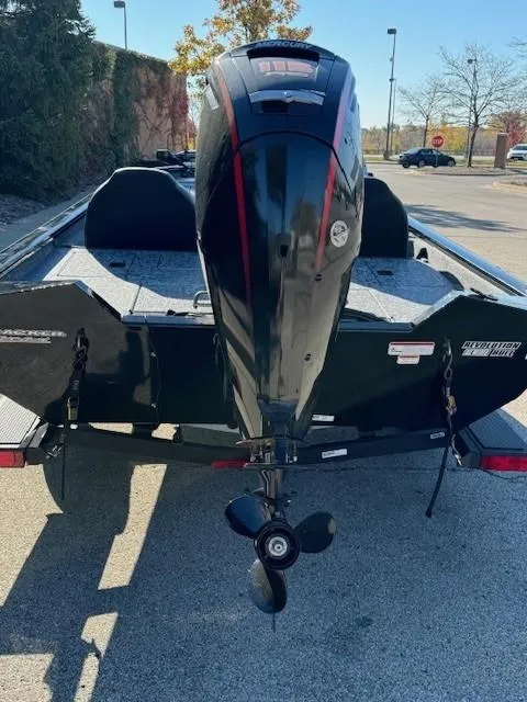 Slide: The Image of 2025 Tracker Pro Team 190 boat with outboard motor, parked outdoors. - 4