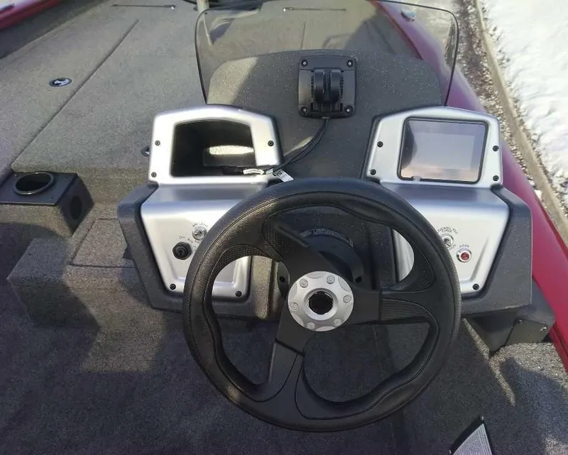 Slide: The Image of 2025 Tracker Pro Team 190 boat dashboard with steering wheel and instrument panels. - 2