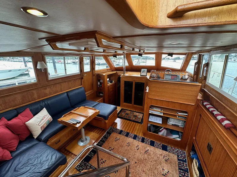 Slide: The Image of Luxurious 1986 C. Raymond Hunt Design yacht interior with wood paneling and cozy seating area. - 10