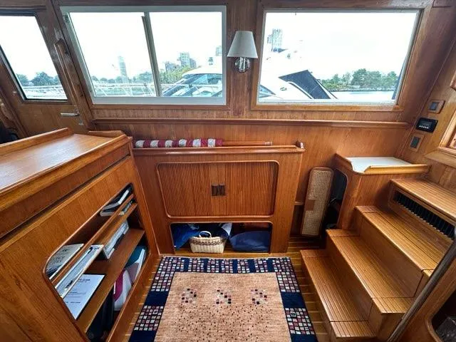 Slide: The Image of Interior of 1986 Custom C. Raymond Hunt Design Yacht with wooden decor and cozy seating area. - 13