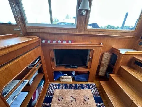 Slide: The Image of Interior of 1986 C. Raymond Hunt Design Yacht with wooden decor and TV. - 14