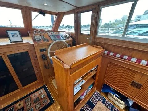 Slide: The Image of Interior of 1986 C. Raymond Hunt Design Yacht with wooden helm and nautical decor. - 15