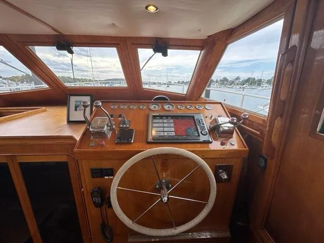 Slide: The Image of 1986 Custom C. Raymond Hunt Design Yacht helm with wooden dashboard and steering wheel. - 17