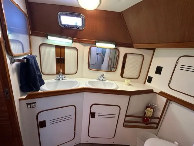 Slide: The Image of Luxurious 1986 C. Raymond Hunt Design yacht bathroom with dual sinks and wooden accents. - 29