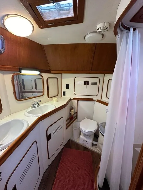 Slide: The Image of 1986 Custom C. Raymond Hunt Design Yacht bathroom with wood accents and modern fixtures. - 31
