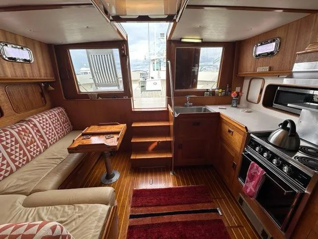 Slide: The Image of Interior of 1986 C. Raymond Hunt Design Yacht with cozy seating and kitchen area. - 33
