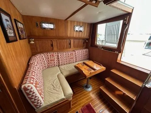 Slide: The Image of Cozy 1986 C. Raymond Hunt Design yacht interior with wood paneling and patterned seating. - 35