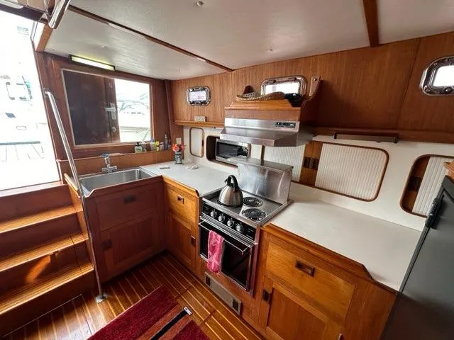 Slide: The Image of 1986 C. Raymond Hunt Design Yacht kitchen with wood cabinetry and modern appliances. - 38