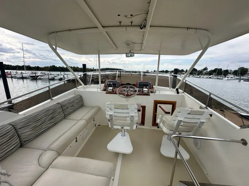 Slide: The Image of Luxurious 1986 C. Raymond Hunt Design Yacht with spacious seating and scenic marina view. - 4
