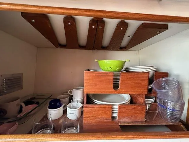 Slide: The Image of Yacht kitchen cabinet with neatly organized dishes and cups, 1986 C. Raymond Hunt Design. - 40
