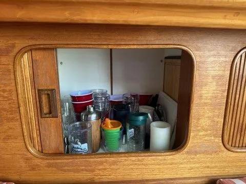 Slide: The Image of Wooden yacht cabinet with assorted cups and glasses, 1986 C. Raymond Hunt Design. - 41