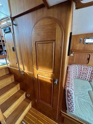 Slide: The Image of 1986 Custom C. Raymond Hunt Design Yacht interior with wooden paneling and cozy seating area. - 42