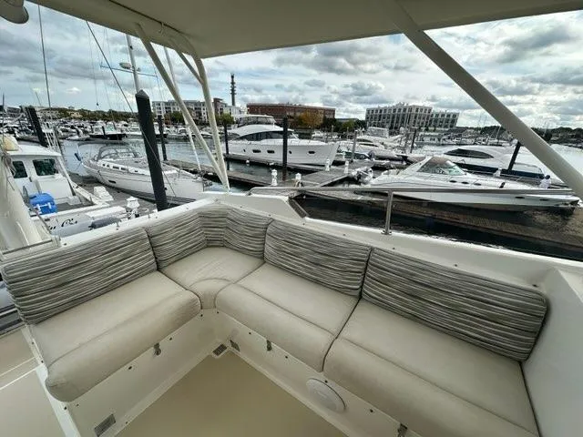 Slide: The Image of Luxurious 1986 C. Raymond Hunt Design yacht with spacious seating, docked at a marina. - 6
