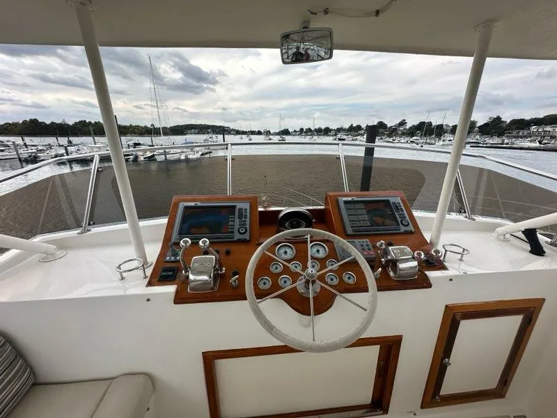 Slide: The Image of Helm of 1986 C. Raymond Hunt Design Yacht with dual controls and scenic marina view. - 7