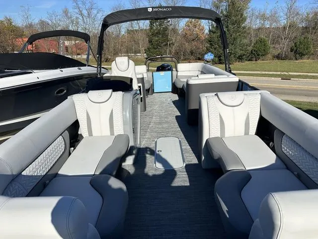 Slide: The Image of 2025 Godfrey Monaco 235SB pontoon boat with spacious seating and modern design. - 4