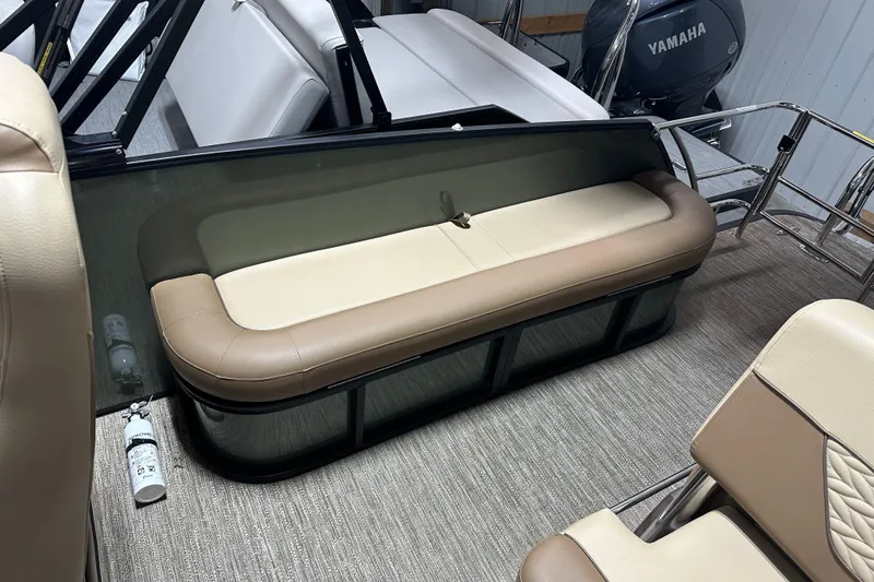 Slide: The Image of 2025 Godfrey MONACO 235 SFL boat interior with beige seating and Yamaha engine. - 10