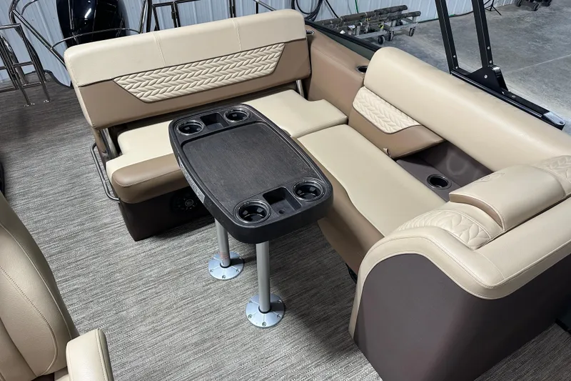 Slide: The Image of Luxurious seating area on 2025 Godfrey MONACO 235 SFL pontoon boat with table and cup holders. - 6