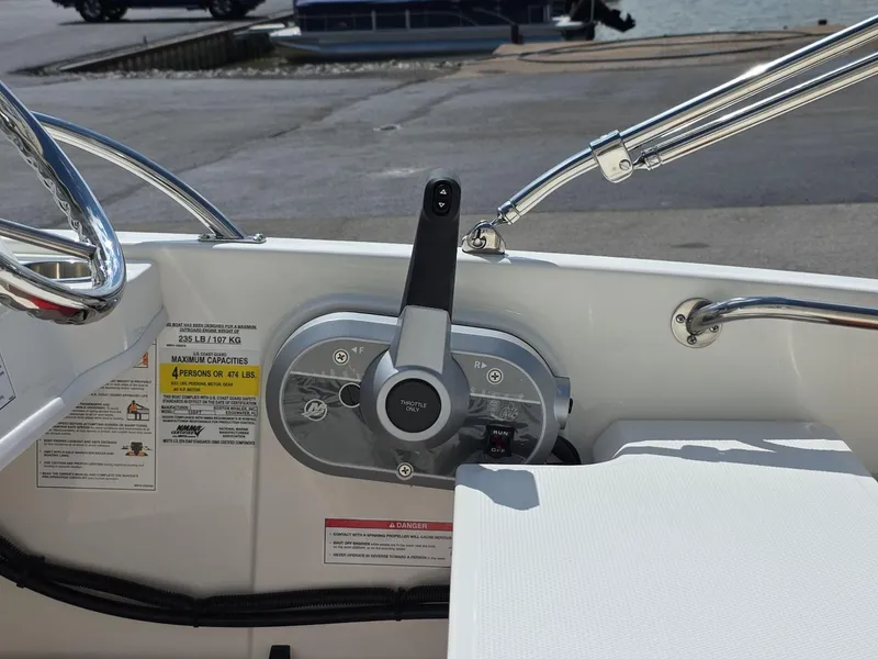 Slide: The Image of 2025 Boston Whaler 130 Super Sport boat control panel with throttle lever. - 10
