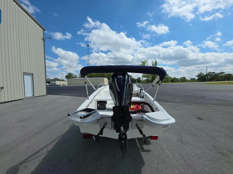 Slide: The Image of 2025 Boston Whaler 130 Super Sport boat parked outdoors under a blue sky. - 5