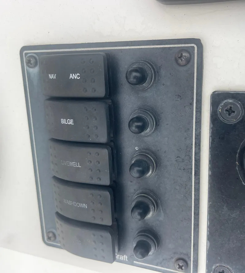 Slide: The Image of Control panel of a 2021 May-Craft 19 Cape Classic boat with labeled switches. - 15