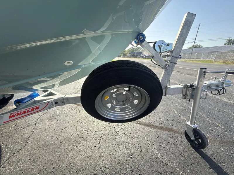 Slide: The Image of 2025 Boston Whaler 130 Super Sport on trailer, close-up of wheel and hitch. - 6