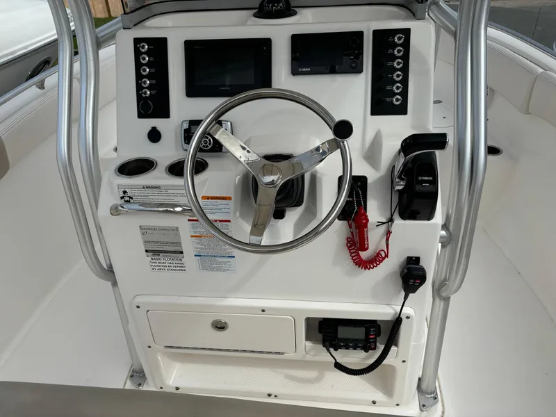 Slide: The Image of 2016 Robalo R222 Center Console dashboard with steering wheel and controls. - 11