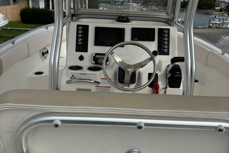 Slide: The Image of 2016 Robalo R222 Center Console boat dashboard with steering wheel and controls. - 12
