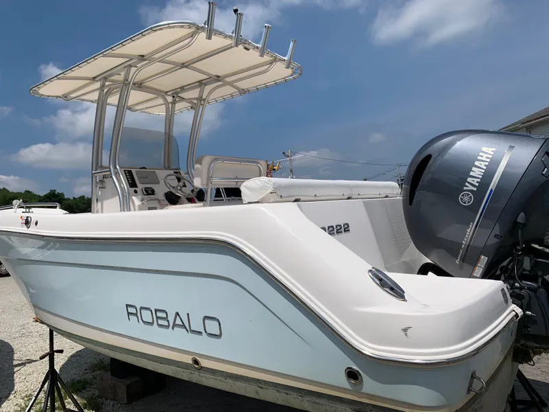 Slide: The Image of 2016 Robalo R222 Center Console boat with Yamaha engine, parked outdoors. - 2