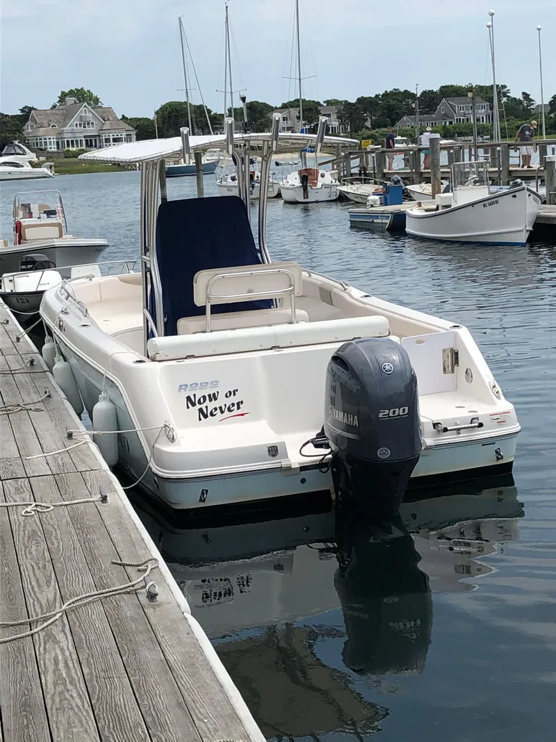 Slide: The Image of 2016 Robalo R222 Center Console boat docked in a marina. - 3