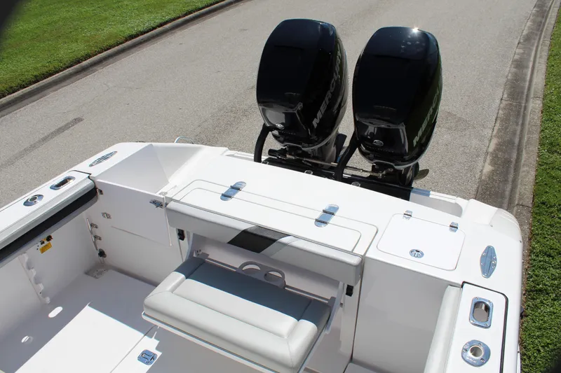 Slide: The Image of 2009 Donzi 35 ZFX Cuddy boat with dual outboard engines, white seating, and sleek design. - 38