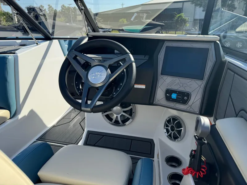 Slide: The Image of 2025 ATX Surf Boats 22 Type-S dashboard with steering wheel and touchscreen display. - 6