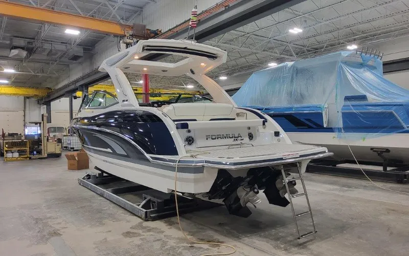 Slide: The Image of 2025 Formula 330 CBR boat in a workshop, showcasing sleek design and modern features. - 2