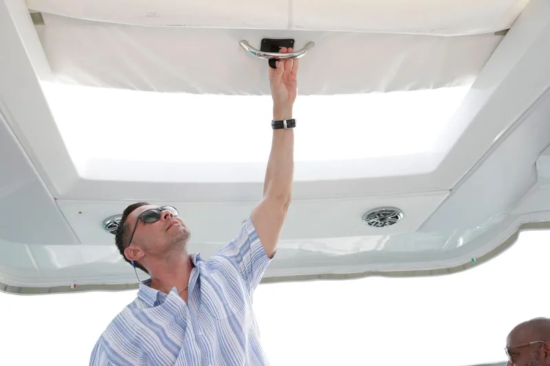 Slide: The Image of Man adjusting sunroof on 2025 Formula 330 CBR boat. - 20