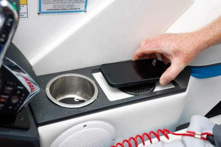 Slide: The Image of 2025 Formula 330 CBR interior with phone charging station and cup holder. - 24