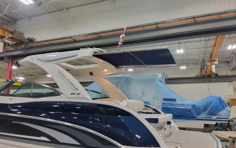 Slide: The Image of 2025 Formula 330 CBR boat in a warehouse, featuring sleek design and modern amenities. - 3