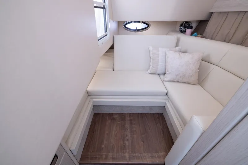 Slide: The Image of Interior of 2025 Formula 330 CBR boat with white seating and wooden flooring. - 41