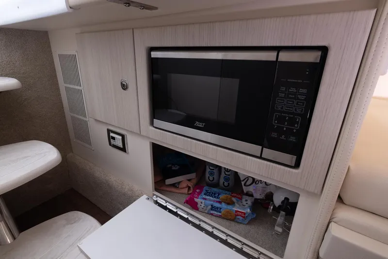 Slide: The Image of 2025 Formula 330 CBR interior with microwave and storage area. - 43