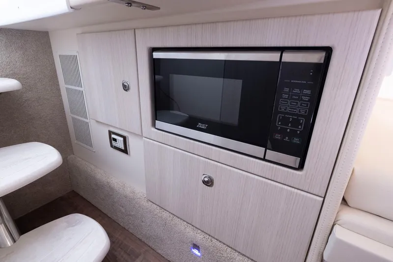 Slide: The Image of 2025 Formula 330 CBR interior with built-in microwave and modern cabinetry. - 44