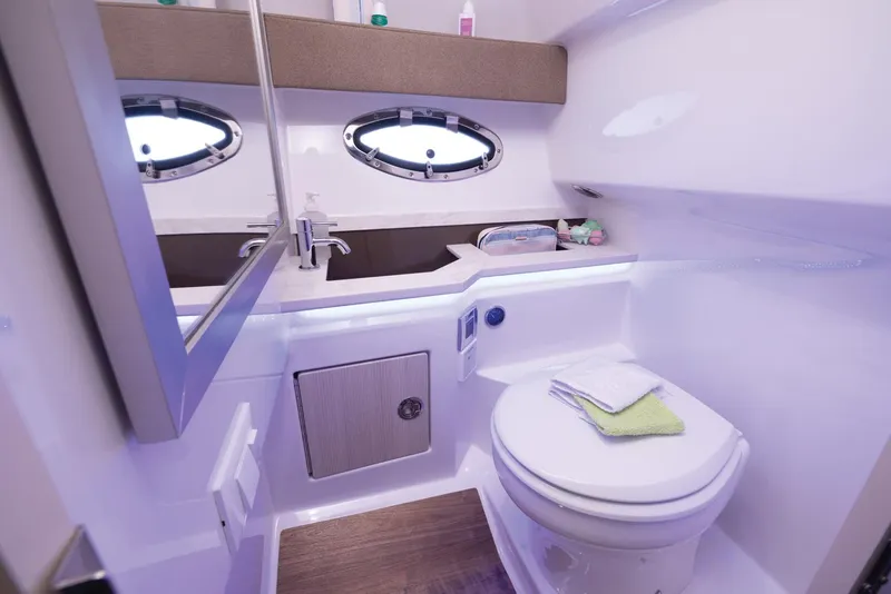 Slide: The Image of 2025 Formula 330 CBR boat bathroom with modern fixtures and porthole windows. - 45