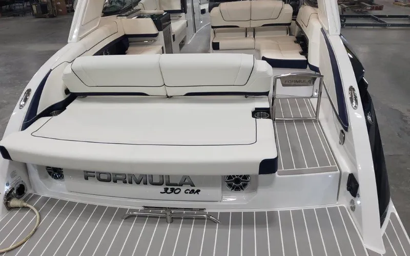 Slide: The Image of 2025 Formula 330 CBR boat with sleek white seating and modern design. - 48