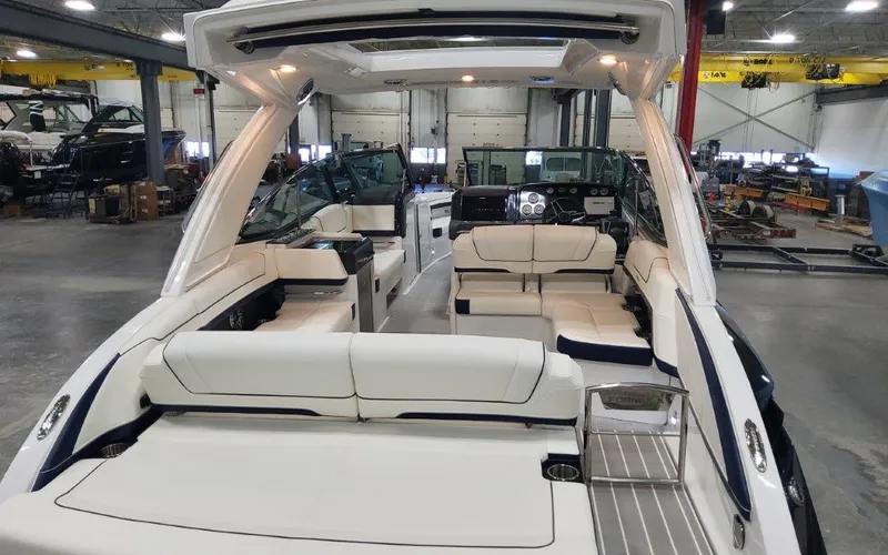 Slide: The Image of 2025 Formula 330 CBR boat interior with white seating in a showroom. - 49