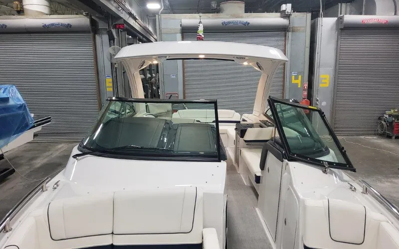 Slide: The Image of 2025 Formula 330 CBR boat in a garage with open doors and seating area. - 9